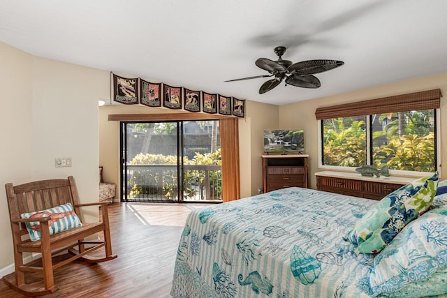 bedroom with hardwood / wood-style flooring, ceiling fan, and multiple windows