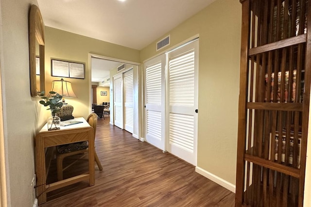 corridor with dark wood-type flooring