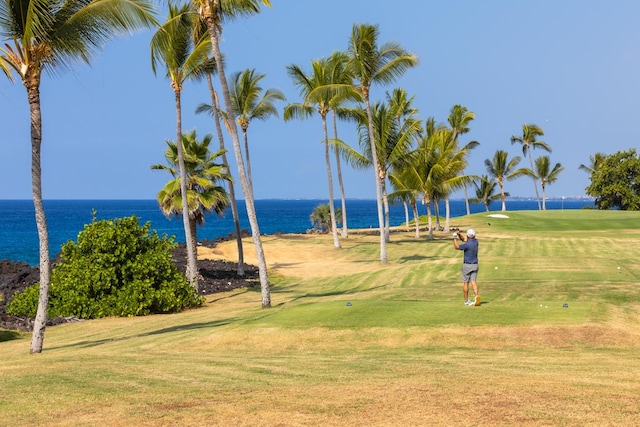 surrounding community with a yard and a water view