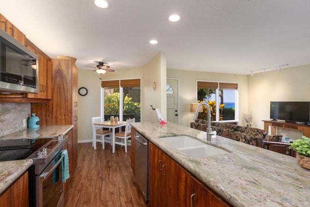 kitchen with ceiling fan, sink, dark wood-type flooring, track lighting, and appliances with stainless steel finishes