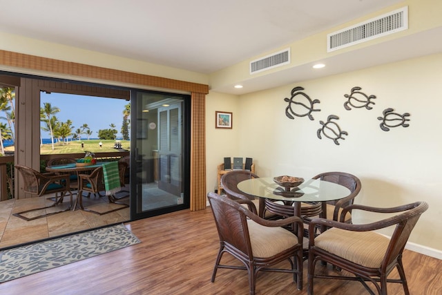 dining space with wood-type flooring