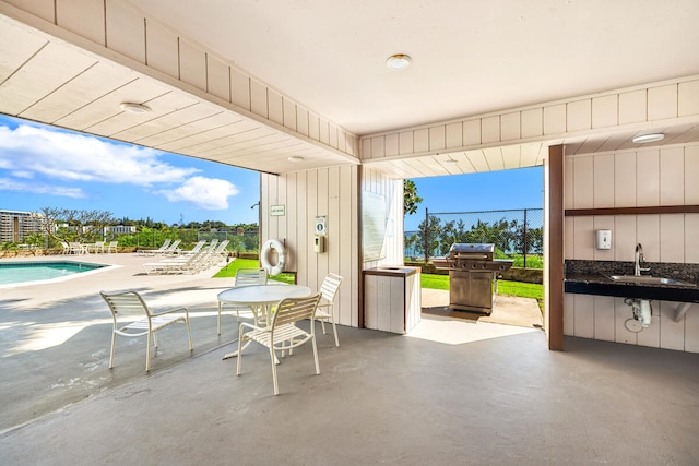 view of patio / terrace with grilling area and sink