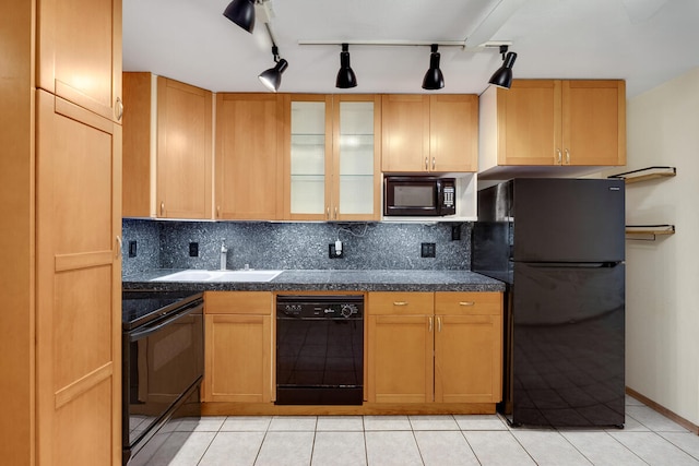 kitchen featuring decorative backsplash, light tile patterned floors, sink, and black appliances