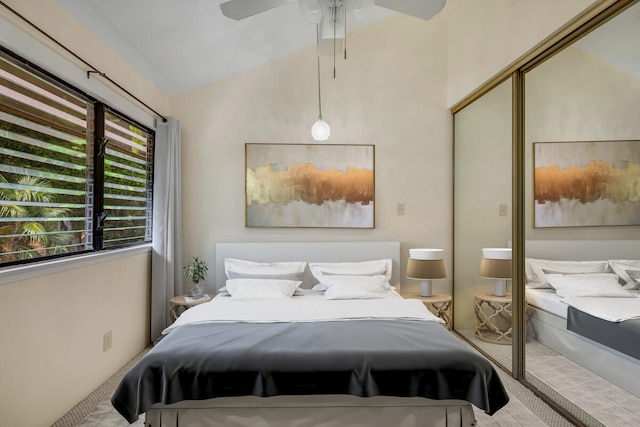 carpeted bedroom featuring ceiling fan and lofted ceiling