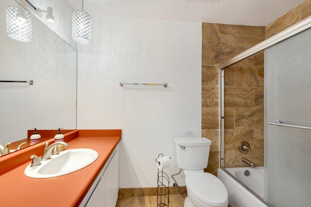 full bathroom featuring tile patterned flooring, vanity, toilet, and enclosed tub / shower combo