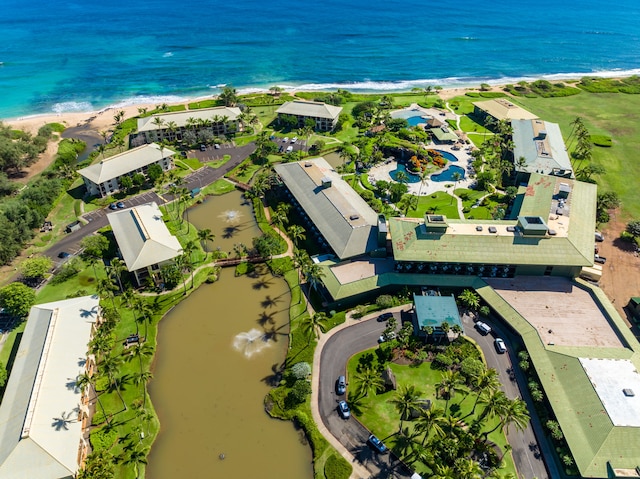 drone / aerial view featuring a water view and a view of the beach