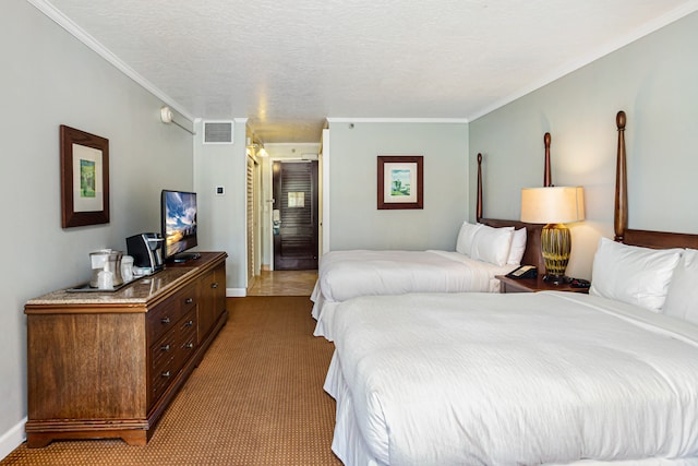 carpeted bedroom featuring a textured ceiling and ornamental molding