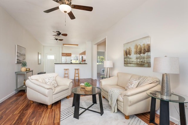 living room featuring ceiling fan and hardwood / wood-style flooring