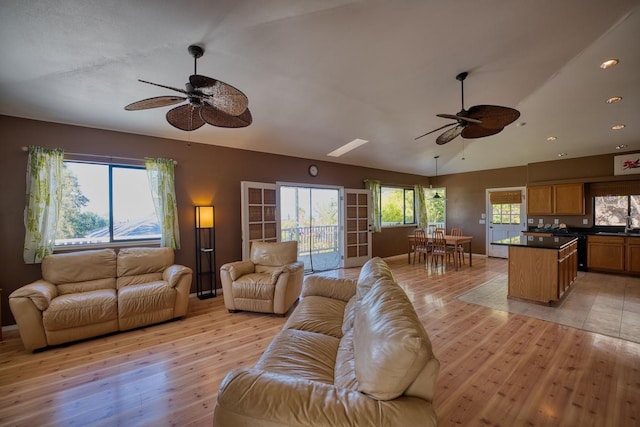 living room featuring ceiling fan and light hardwood / wood-style flooring