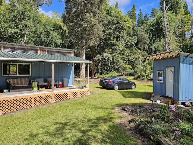 view of yard with outdoor lounge area and a storage shed