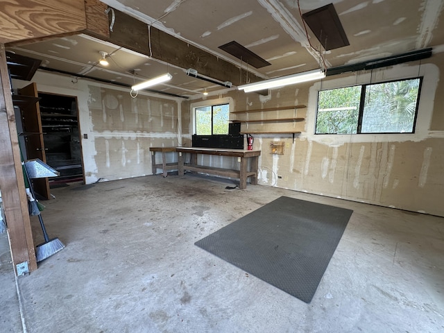 miscellaneous room with a workshop area and concrete floors