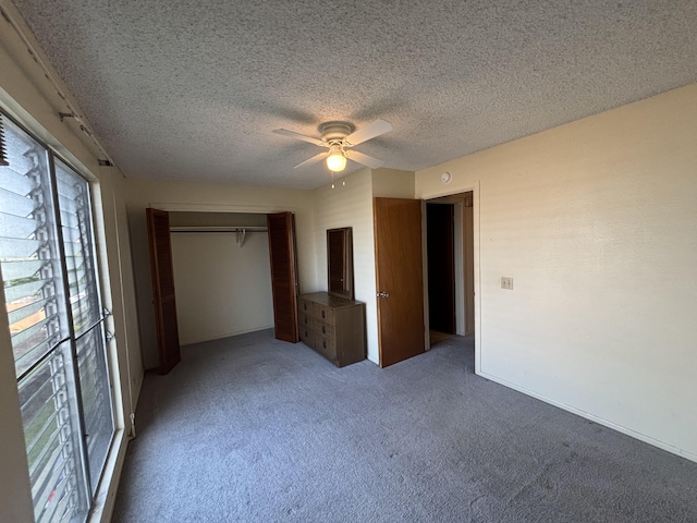 unfurnished bedroom with light carpet, ceiling fan, a closet, and a textured ceiling