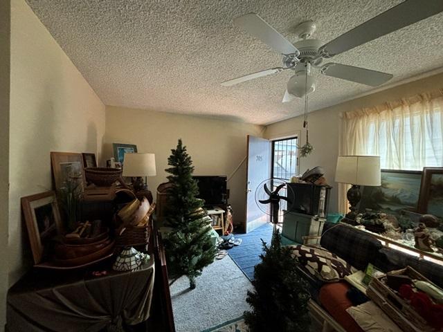 interior space featuring a textured ceiling and a ceiling fan