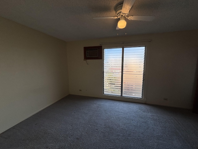 carpeted empty room featuring a textured ceiling, an AC wall unit, ceiling fan, and baseboards