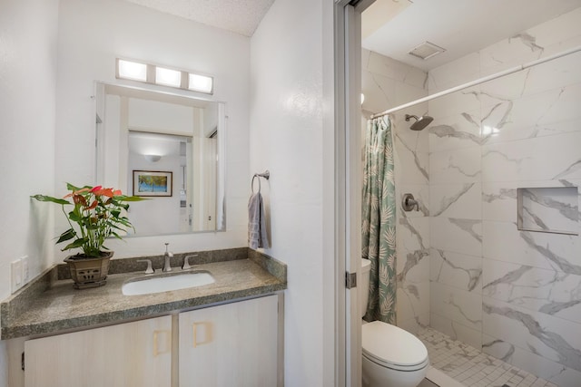 bathroom featuring vanity, curtained shower, and toilet