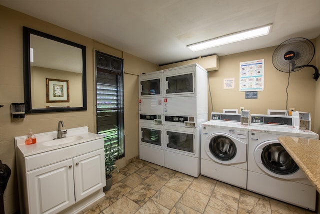 laundry area featuring washer and dryer, stacked washer / dryer, and sink