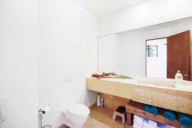 bathroom with tile patterned flooring, vanity, and toilet