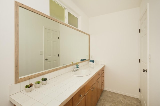 bathroom with baseboards and vanity