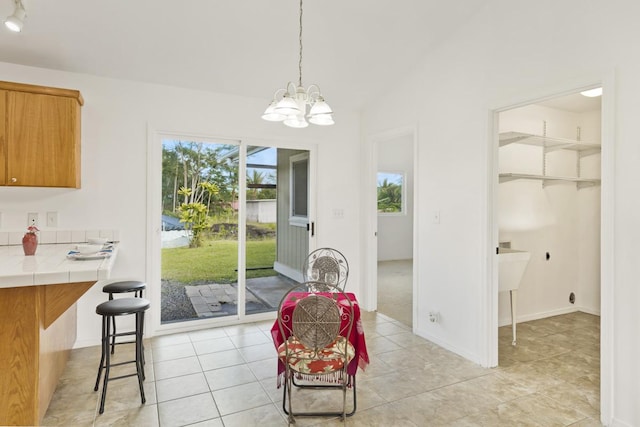 dining area with a chandelier and light tile patterned floors