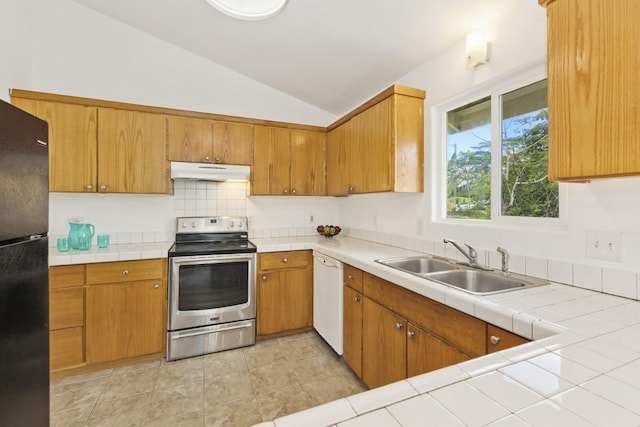 kitchen featuring stainless steel electric range oven, freestanding refrigerator, a sink, under cabinet range hood, and dishwasher