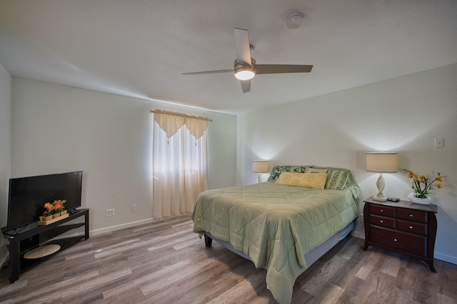 bedroom featuring ceiling fan and hardwood / wood-style floors