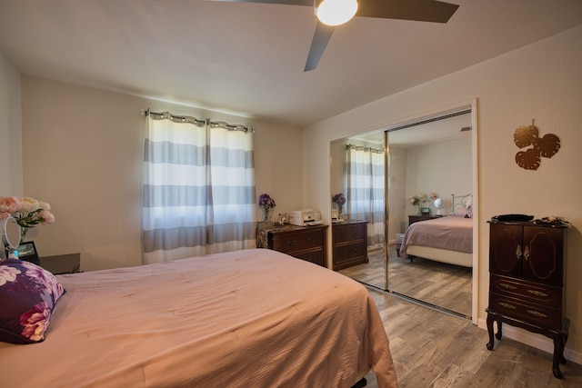 bedroom featuring hardwood / wood-style floors, a closet, and ceiling fan