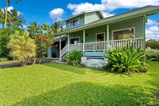 exterior space featuring a lawn and covered porch