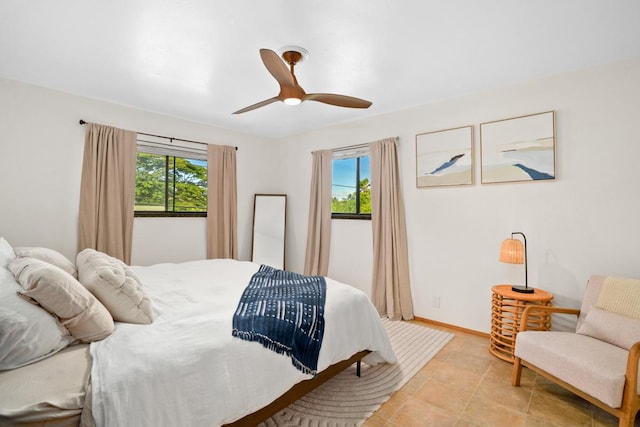 tiled bedroom featuring ceiling fan