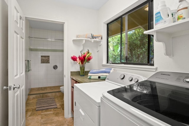 washroom with washer and dryer