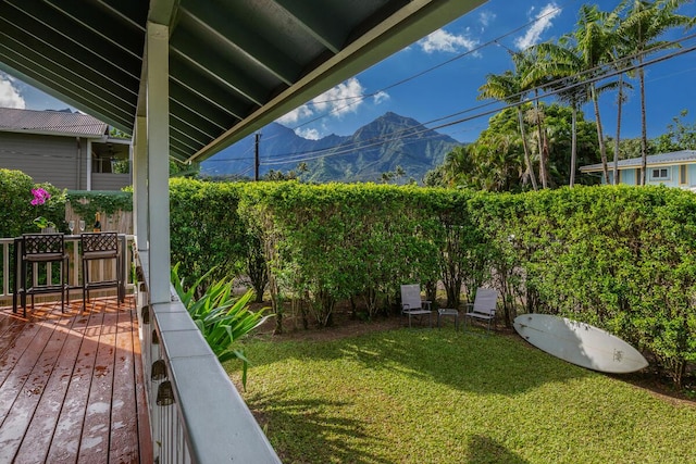 view of yard featuring a mountain view and a balcony