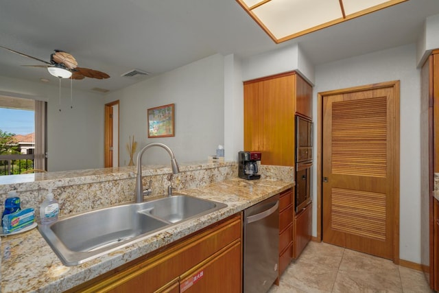 kitchen with ceiling fan, dishwasher, light stone countertops, sink, and light tile patterned floors