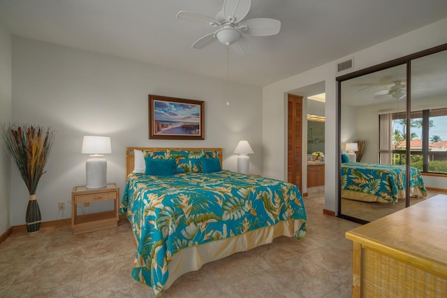 bedroom featuring ensuite bathroom, ceiling fan, light tile patterned floors, and a closet