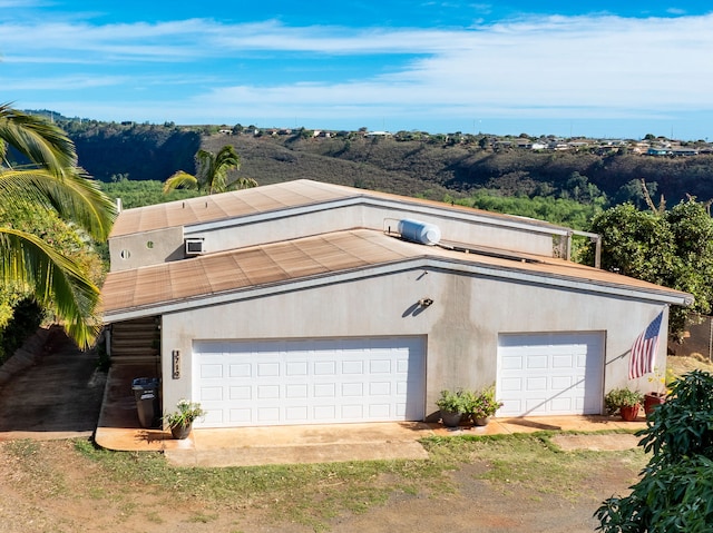 exterior space featuring a garage and an outdoor structure