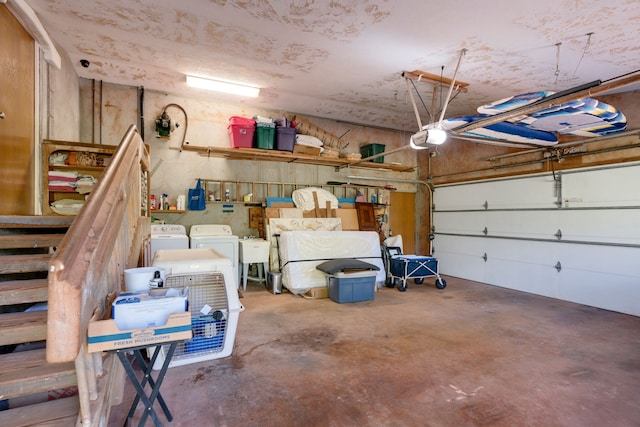 garage with washer and clothes dryer, a garage door opener, and sink