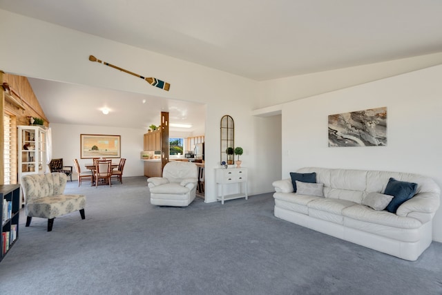 living room featuring carpet and vaulted ceiling