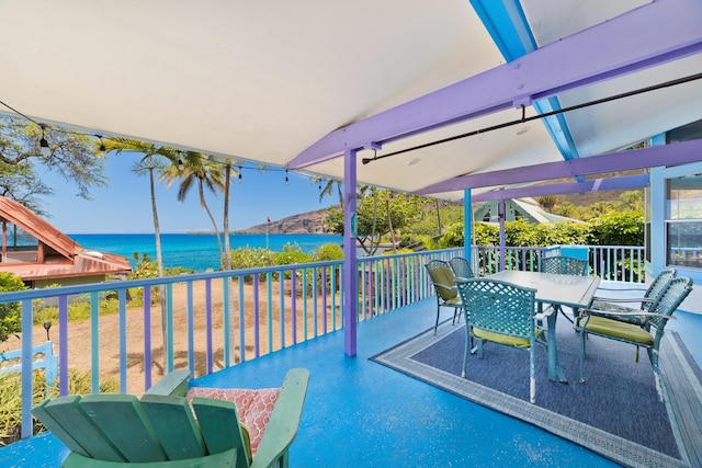 view of patio / terrace with a water view and a balcony