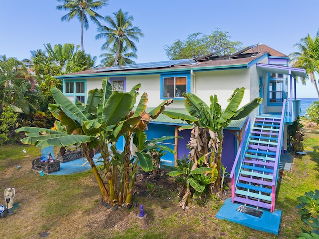 view of front of property featuring solar panels