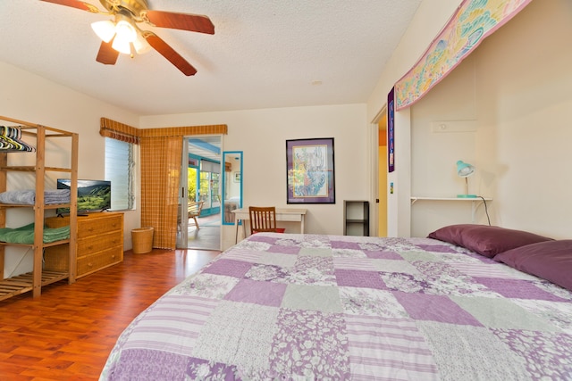 bedroom with a textured ceiling, access to outside, ceiling fan, and dark wood-type flooring