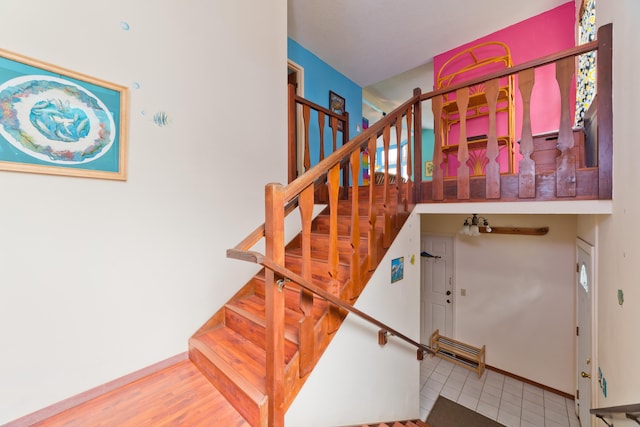 stairs with hardwood / wood-style floors