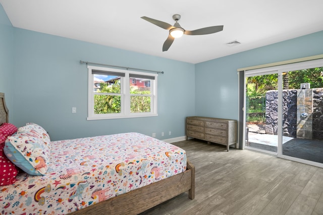 bedroom with wood-type flooring, access to outside, and ceiling fan