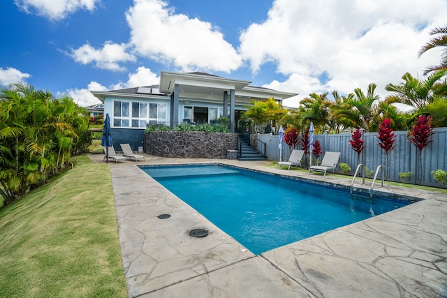 view of pool featuring a yard and a patio