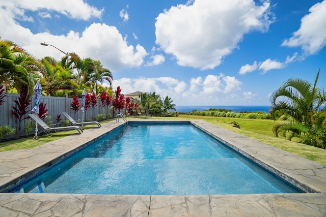 view of swimming pool featuring a water view