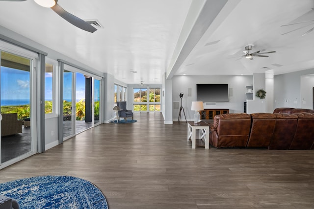 living room featuring ceiling fan and dark hardwood / wood-style floors