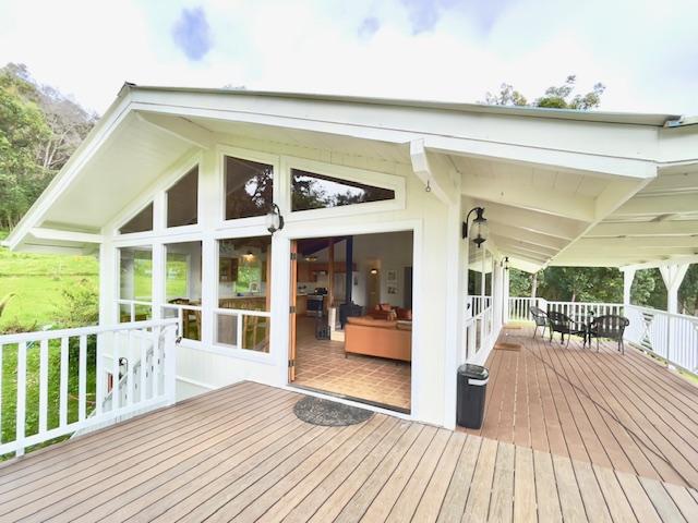 wooden deck with a sunroom