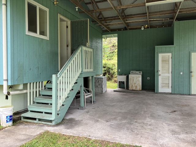 entrance to property with a patio, washer / clothes dryer, and sink