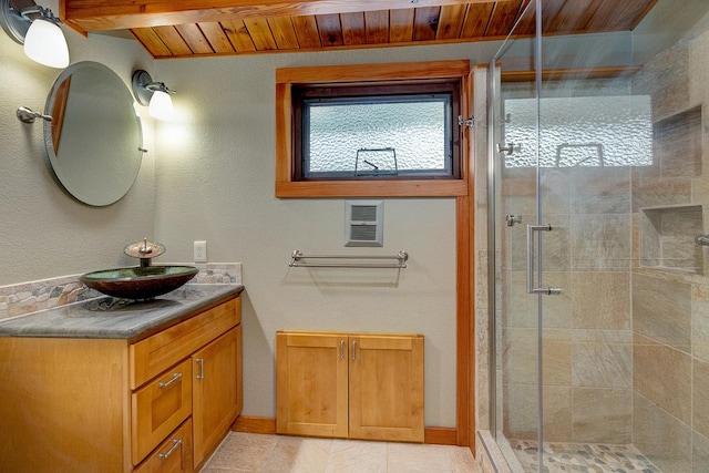 bathroom featuring tile patterned floors, vanity, a shower with shower door, and wooden ceiling