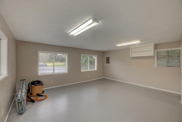 spare room featuring concrete flooring and electric panel