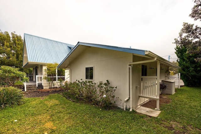 view of property exterior featuring a yard and a patio