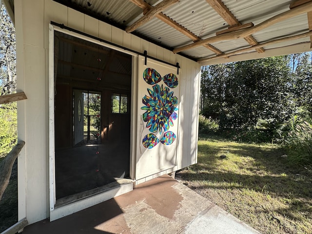 view of exterior entry with a lawn