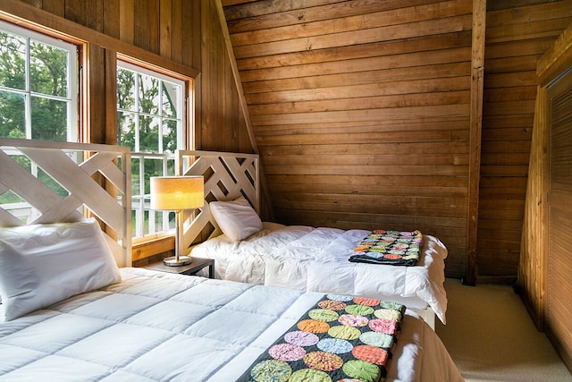 bedroom with wood walls and lofted ceiling